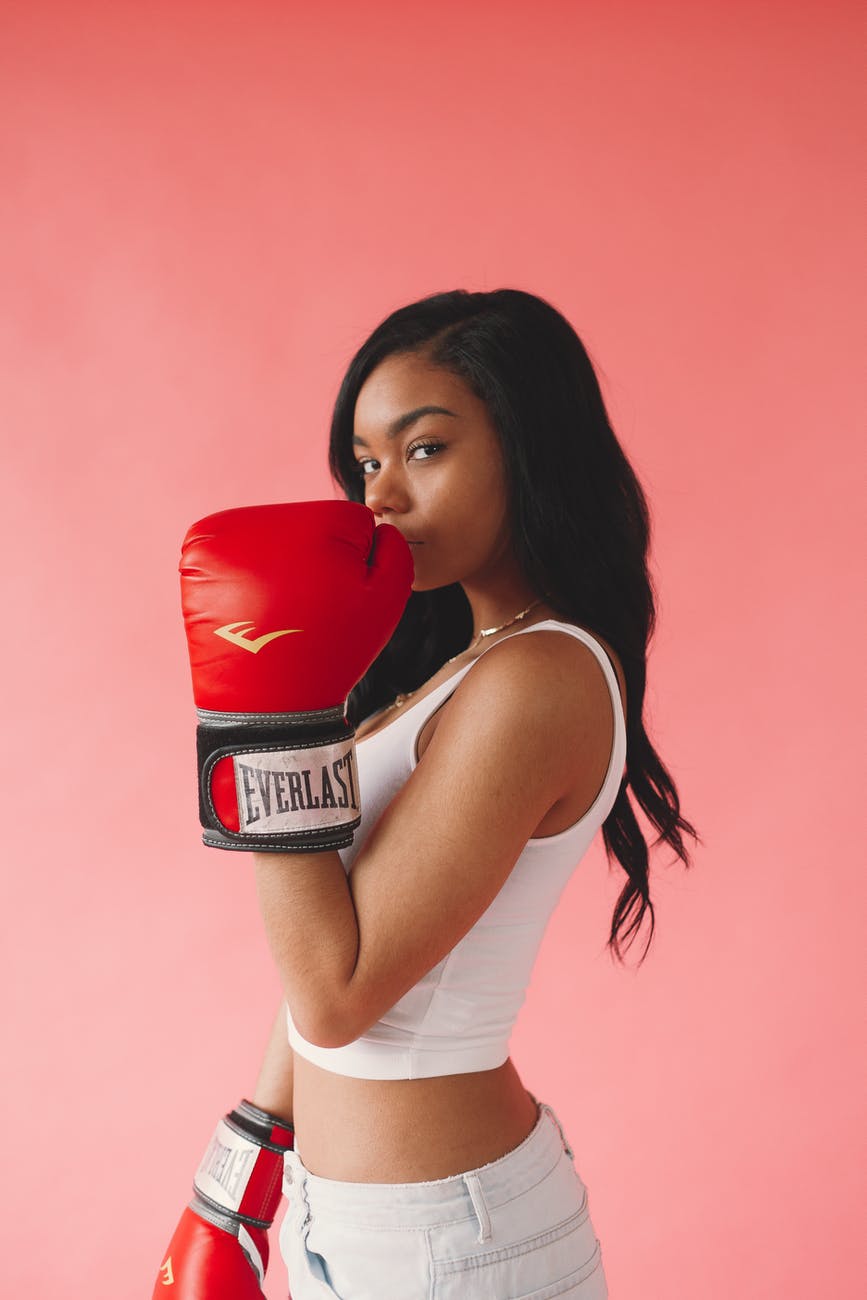 photo of woman wearing red boxing gloves