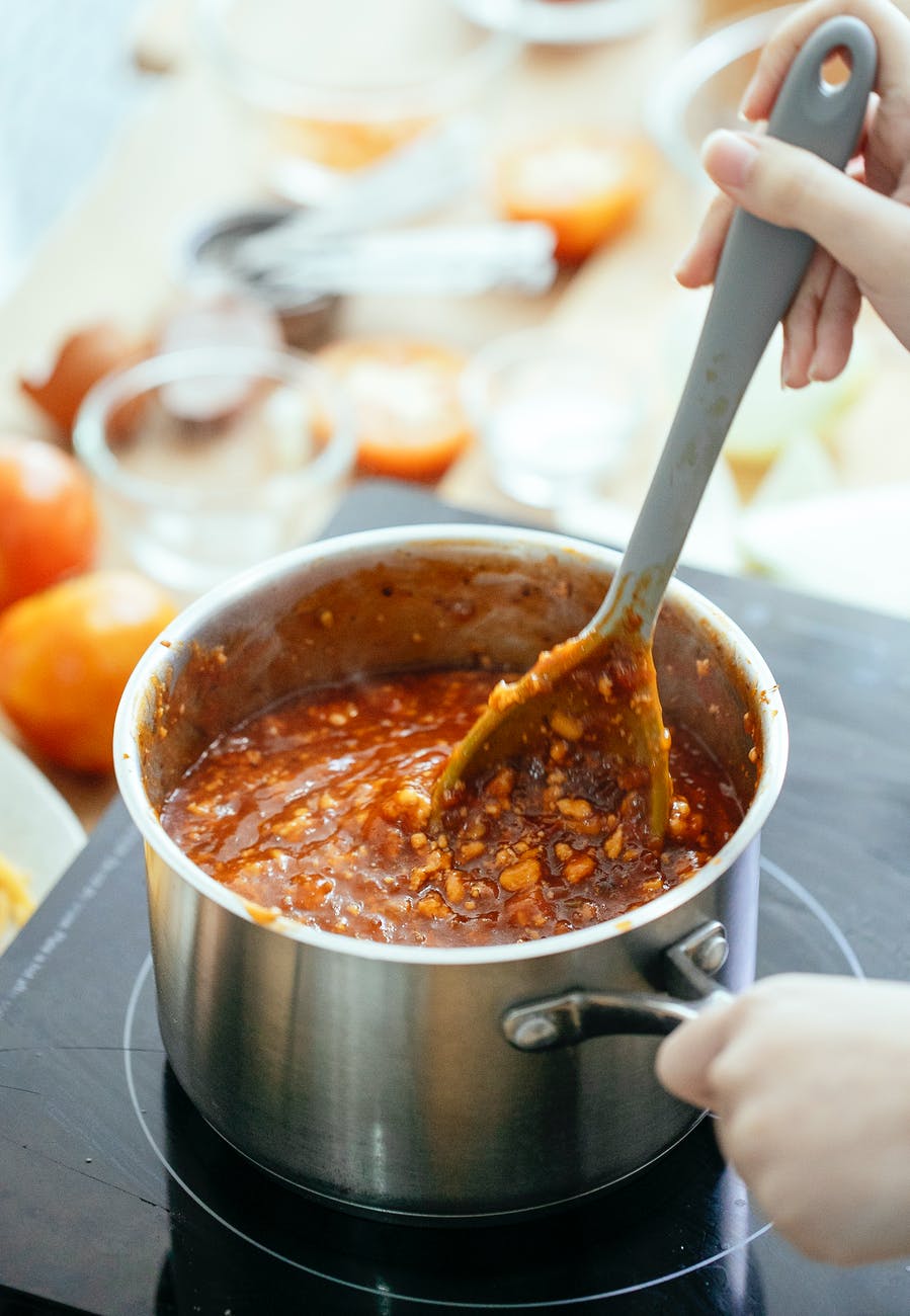 crop person cooking delicious chili