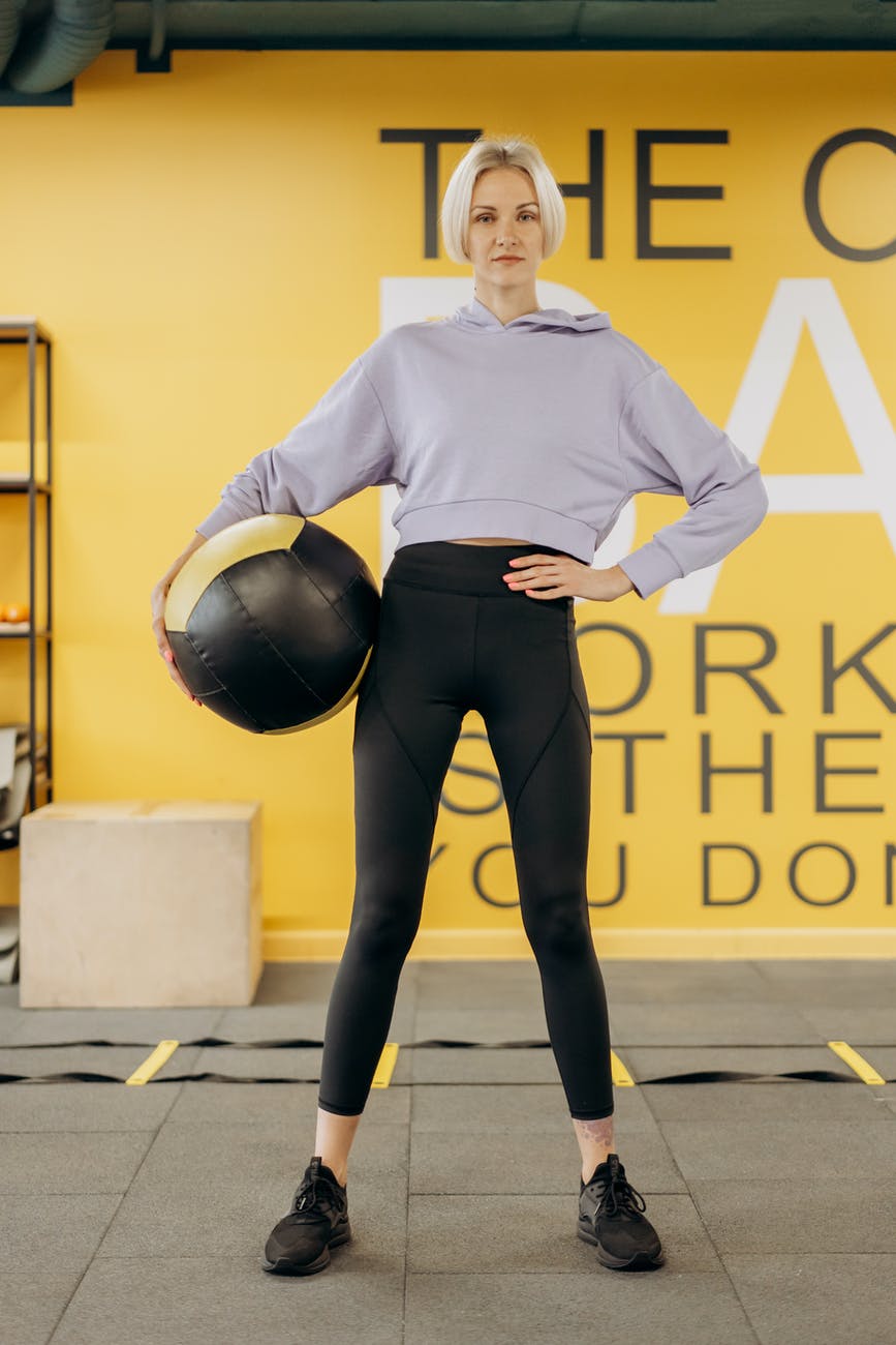 woman standing with an exercise ball