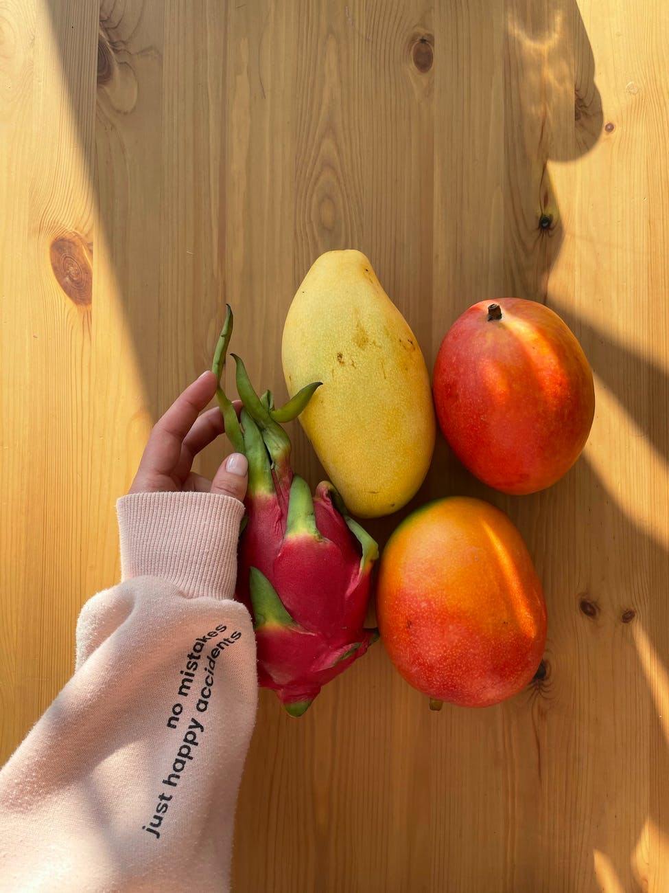 woman exotic tropical fruit from wooden table